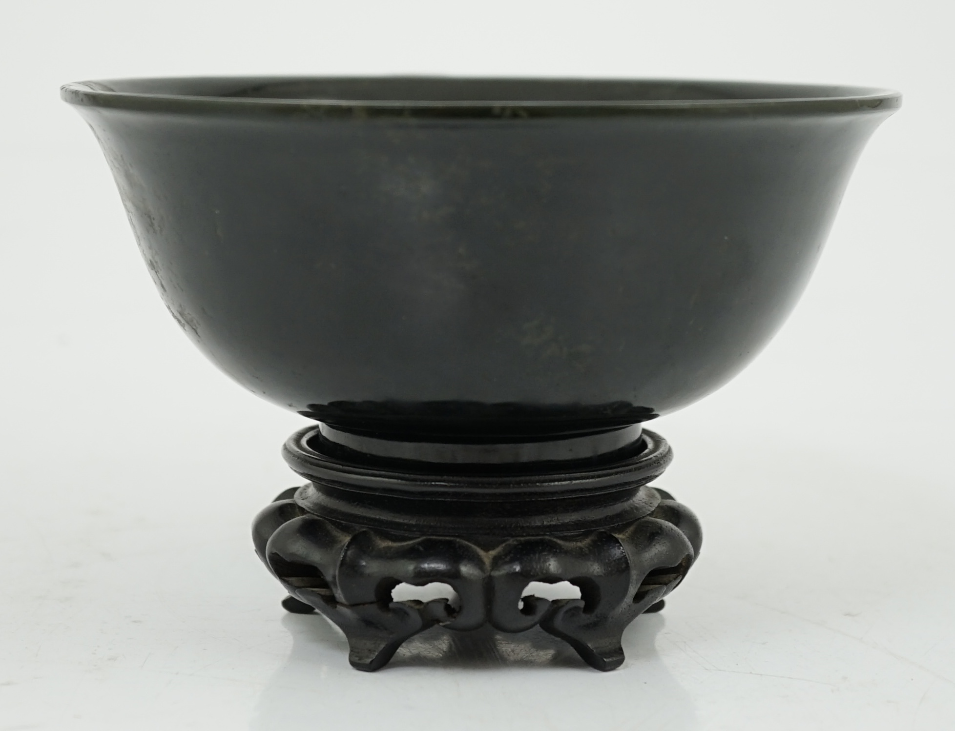 A Chinese dark spinach green jade bowl, engraved Qianlong seal mark but 19th/20th century